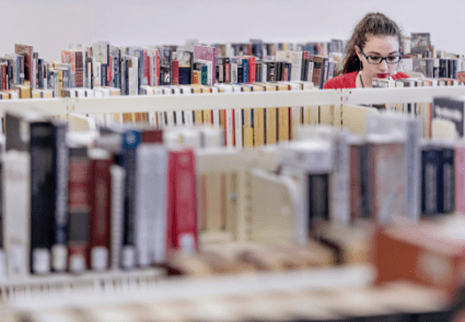 Student browses in a row of books