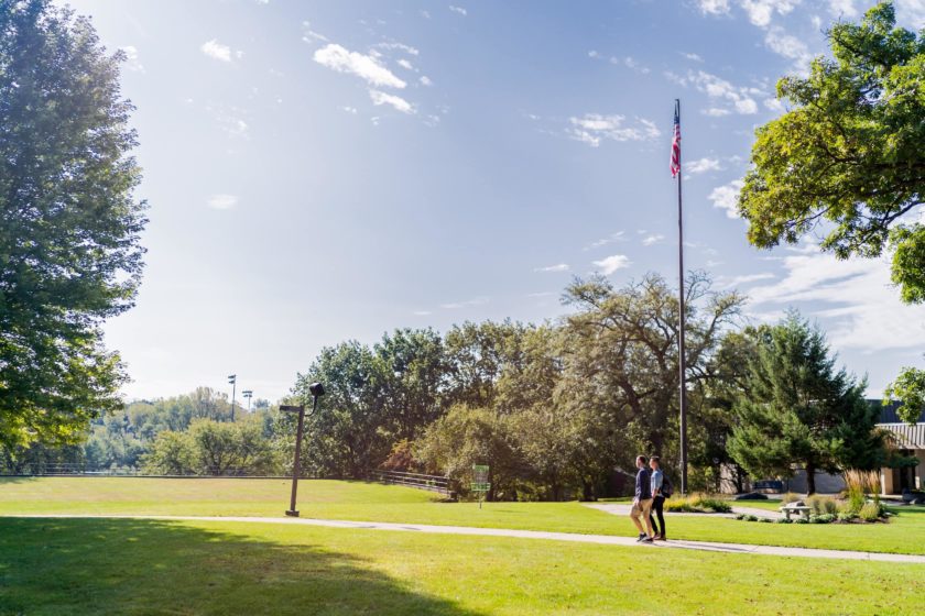 Students walking around a American campus during Summer