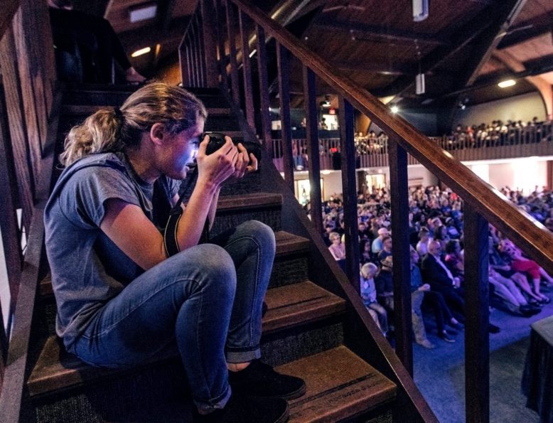 Student taking photos of a chapel service