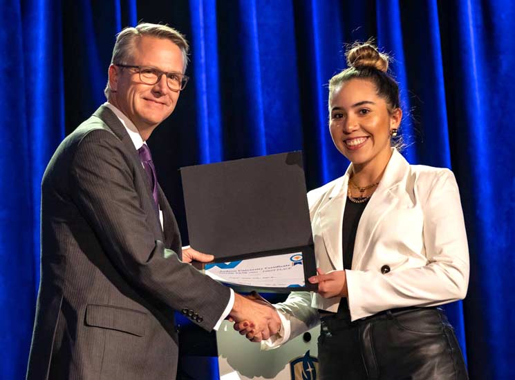 Student and President Crume shaking hands at the Shark Tank event