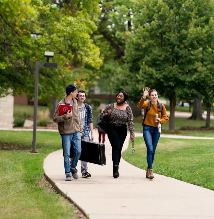 Students walking and talking on campus