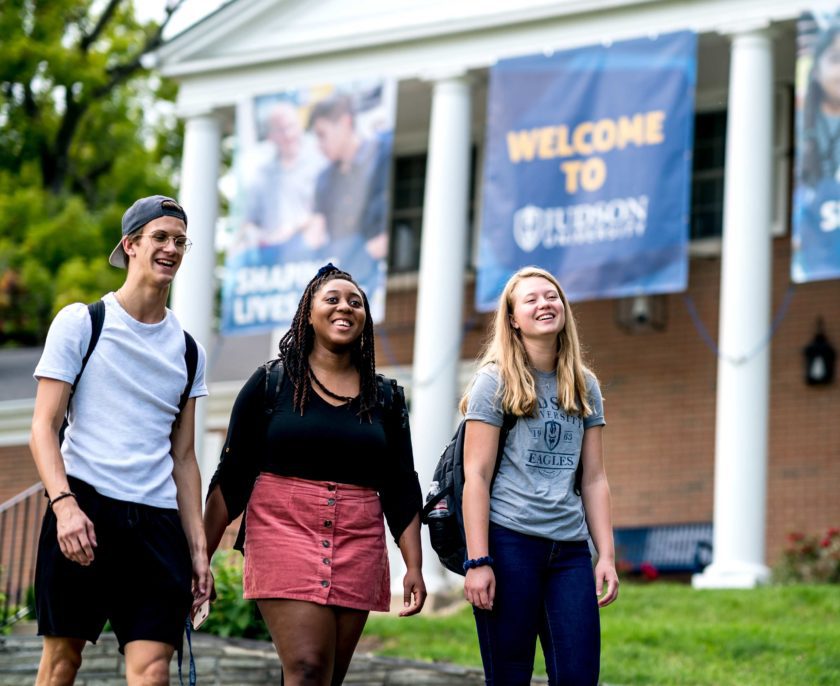 Students walking outside of the admissions building