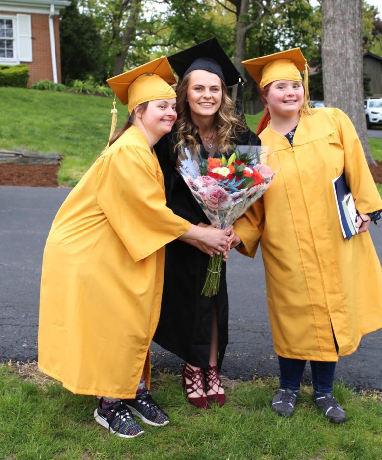 RISE Students and an education smiling at graduation