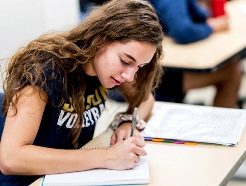 Student taking notes in class