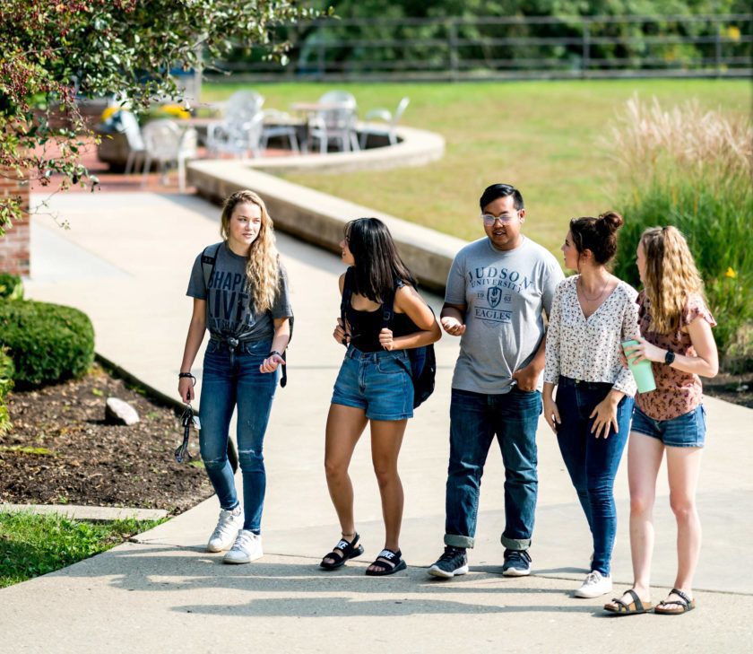 Students walking and talking on campus