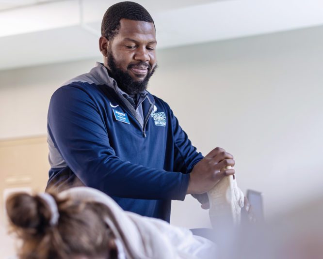 Judson athletic trainer helping a student athlete