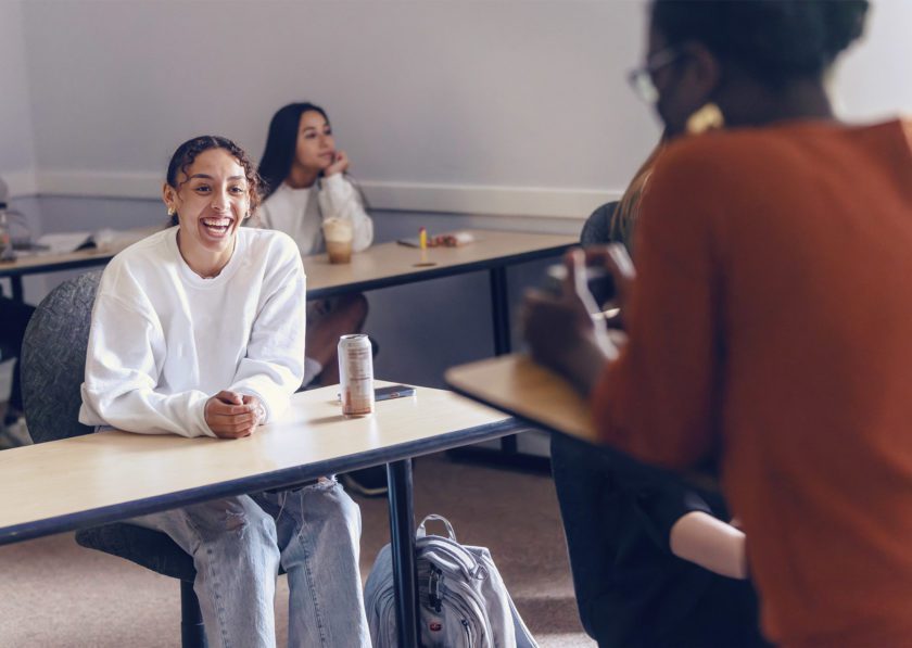 Student speaking with professor during class